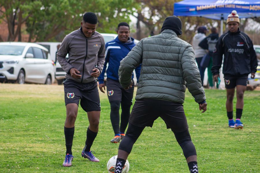 Coaches and players watching the ball