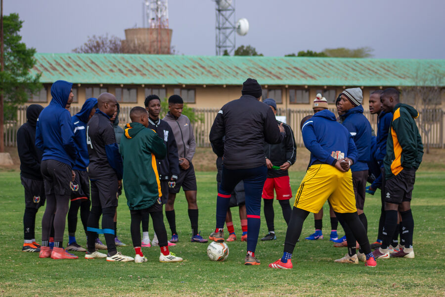 A squad gathers in a group huddle