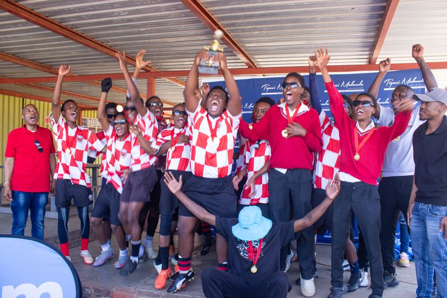 A team celebrates with the trophy